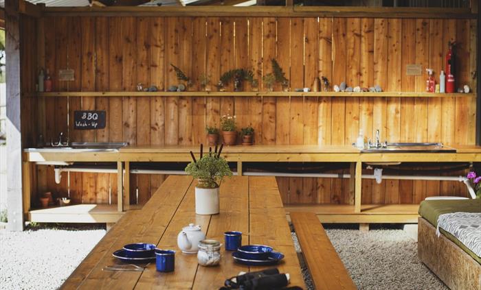 A covered outdoor dining and living space.